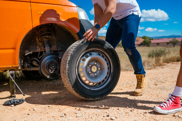 Changing a tire during a road trip adventure in Spain