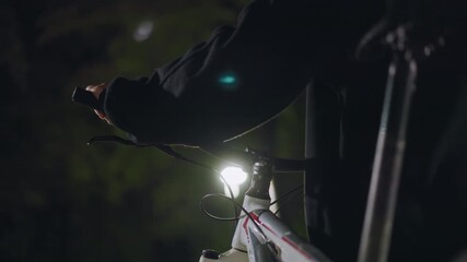 Bike Light Adjustment, Nighttime Bicycle Safety Check, Closeup Of Hand Adjusting Bike Headlight At Night, Reflective Lamp Glow Highlights Careful Preparation Before Urban Cycling Journey