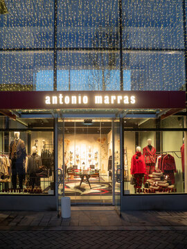 Antonio Marras luxury boutique at Fidenza Village, Italy, during Christmas shopping season with festive lights