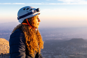 Sunrise view from summit with hiker in helmet