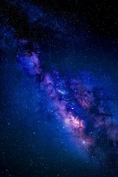 Night sky features a mesmerizing Milky Way galaxy with brilliant stars and colorful hues, capturing the essence of cosmic wonder and the beauty of the universe