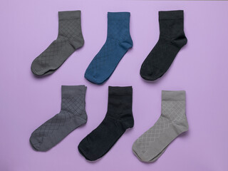 Colorful Variety of Patterned Socks on Vibrant Purple Background