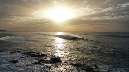 I watch the waves and contemplate the sunset by the sea