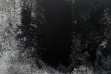 Texture of paper with black ink as background, top view