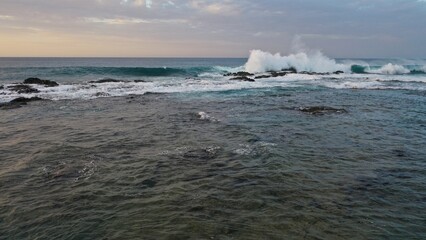 I watch the waves and contemplate the sunset by the sea