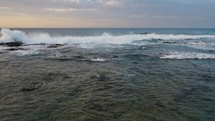 I watch the waves and contemplate the sunset by the sea