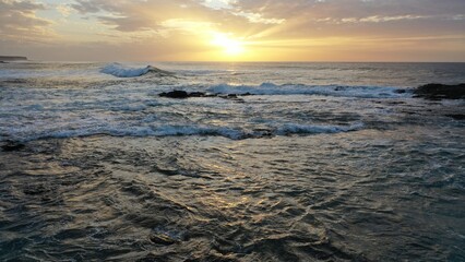 I watch the waves and contemplate the sunset by the sea