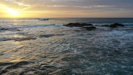 I watch the waves and contemplate the sunset by the sea