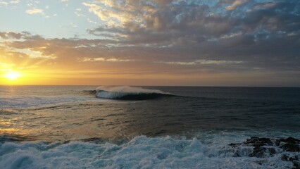 I watch the waves and contemplate the sunset by the sea