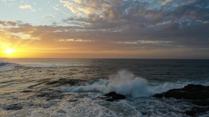 I watch the waves and contemplate the sunset by the sea