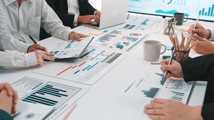 A diverse group of professionals engages in data analysis and brainstorming in a modern office environment, showcasing collaboration on business insights with various charts and graphs. SACTR