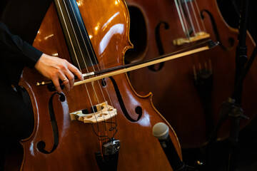 Musician Playing Cello On Dark Stage Close Up