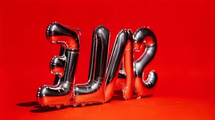 Shiny metallic balloon letters form word sale on vibrant red background offering bold modern promotion design for retail marketing and seasonal discount campaigns
