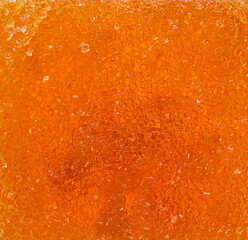 A close up of a yellow substance with a grainy marmalade texture