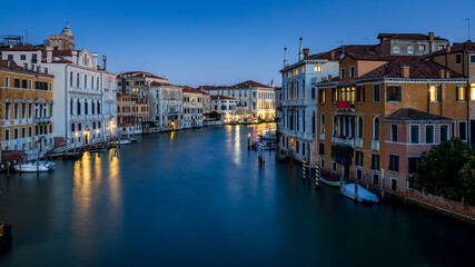 Morning in Venice - view from the Accademia Bridge on the Grand Canal, reflecting the lights from the surrounding houses and the blue sky - long exposure