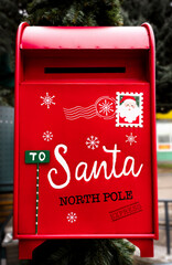 Bright red mailbox for Santa&rsquo;s letters capturing the spirit of Christmas wishes and the magic of Santa&rsquo;s tradition. Close-up.