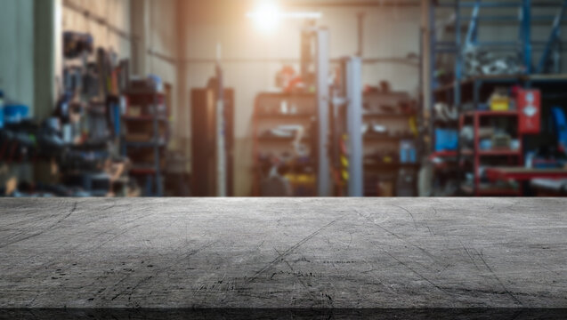 A metal countertop and interior of a car repair shop with spare parts and a car lift - Powered by Adobe