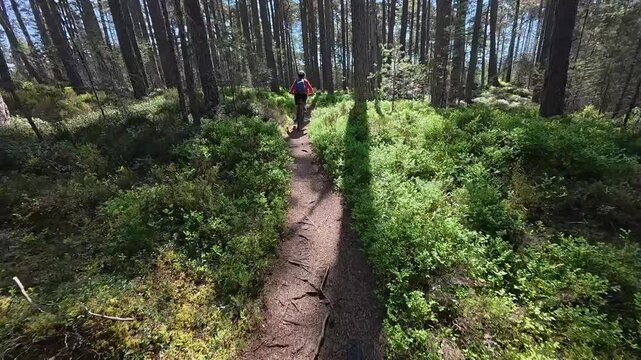 nice senior woman riding her electric mountain bike  in the highlands of Cairn Gorms National Park , Scotland, UK