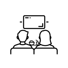 Two people watching television while relaxing on the sofa  