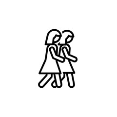 Two women walking together in matching dresses  