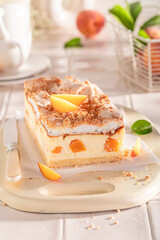 Fresht and sweet peach cheesecake with meringue, foam and fruits.