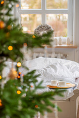 Soft blankets lie while warm drinks wait on a tray, creating a cozy morning atmosphere