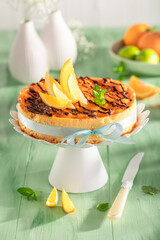 Sweet and homemade cheesecake served on green table.