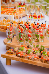 A colorful setup features various gourmet appetizers, beautifully arranged on wooden platters