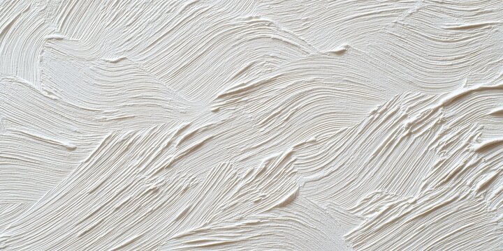 An abstract, high-key close-up captures the dramatic, rhythmic brushstrokes of thick plaster or white paint applied in sweeping curves.