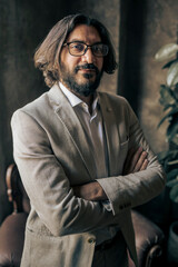 Confident business professional posing in elegant office environment with natural light