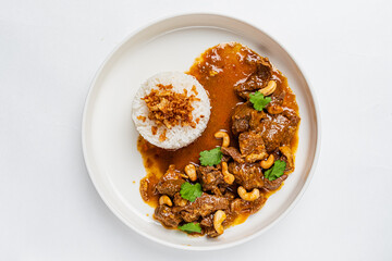 Tasty beef curry with fluffy rice and crispy onions for extra flavor