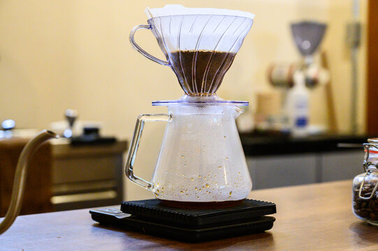 Pour over coffee brewing with v60 dripper on scale