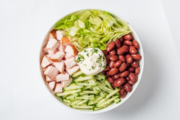 Crisp lettuce, cucumber, and beans combine with tender chicken and dressing for a fresh feast