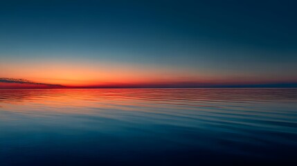 Fototapeta premium Serene coastal landscape reflects vibrant sunset colors across wet sand and incoming tide