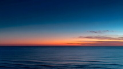 Obraz premium Horizon line displays gradient colors of sunset over the vast ocean surface