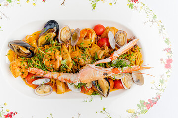 A stunning seafood pasta showcases plump shrimp, mussels, and fresh herbs on a beautiful plate