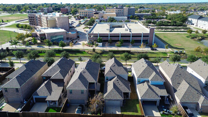 Housing clusters and hotel complex with multilevel parking garage, canal bordered walking paths, trees integrating natural elements for recreational appeal, mixed use development Flower Mound, TX