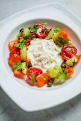 Colorful salad with fresh vegetables and creamy dressing served at a delightful outdoor gathering