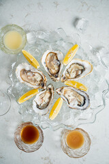 Enjoy a platter of fresh oysters on ice, elegantly garnished with lemon and paired with drinks
