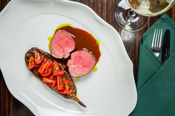 Tender lamb served with vibrant tomatoes and a flavorful sauce, creating a culinary delight