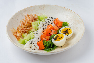 Savory sushi bowl features rice, fresh salmon, cucumber, and boiled eggs, beautifully presented
