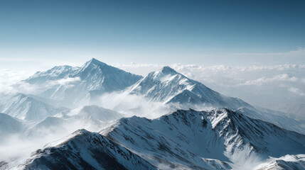 Majestic snow-capped mountain range under a clear blue sky, aerial view. The stunning peaks rise above the clouds, creating a breathtaking panorama of the natural world