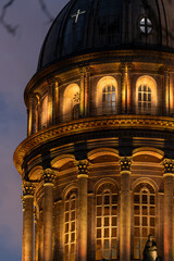 Obraz premium Evening view of the historic basilica dome in Boulogne-sur-Mer, lit warmly against a sky. Illuminated dome of the Basilica of Notre-Dame de Boulogne-sur-Mer glowing at dusk above the old town rooftops