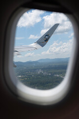 Fototapeta premium Aircraft wing through airplane window during takeoff