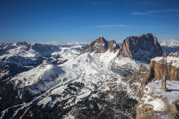 Scenic Mountain Landscape with a View of the Dolomites, featuring the iconic Sassolungo Massif under Clear Blue Sky. Winter Rocky Outdoor Scenery in Northeastern Italy from Viewpoint.