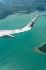 Fototapeta premium Scoot Airbus A321neo in a right turn over the coast of Phuket.