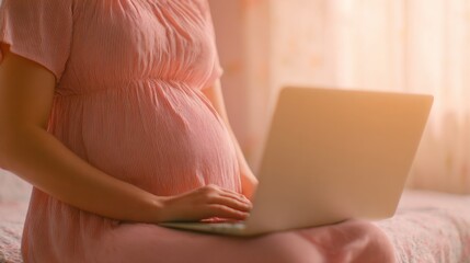 Pregnant woman working on laptop at home during daytime hours