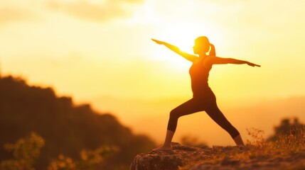 Woman practices yoga at sunset on a rocky landscape near mountains