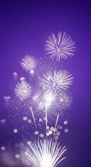 Fototapeta premium Explosion of white fireworks against a purple sky, creating a festive visual, representative of celebration, achievement, or event climax, perfect for backgrounds