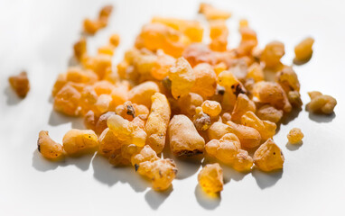 Frankincense olibanum resin, Boswellia sacra Isolated on white background. Frankincense or olibanum aromatic resin used in incense and perfumes, border design, macro shot 